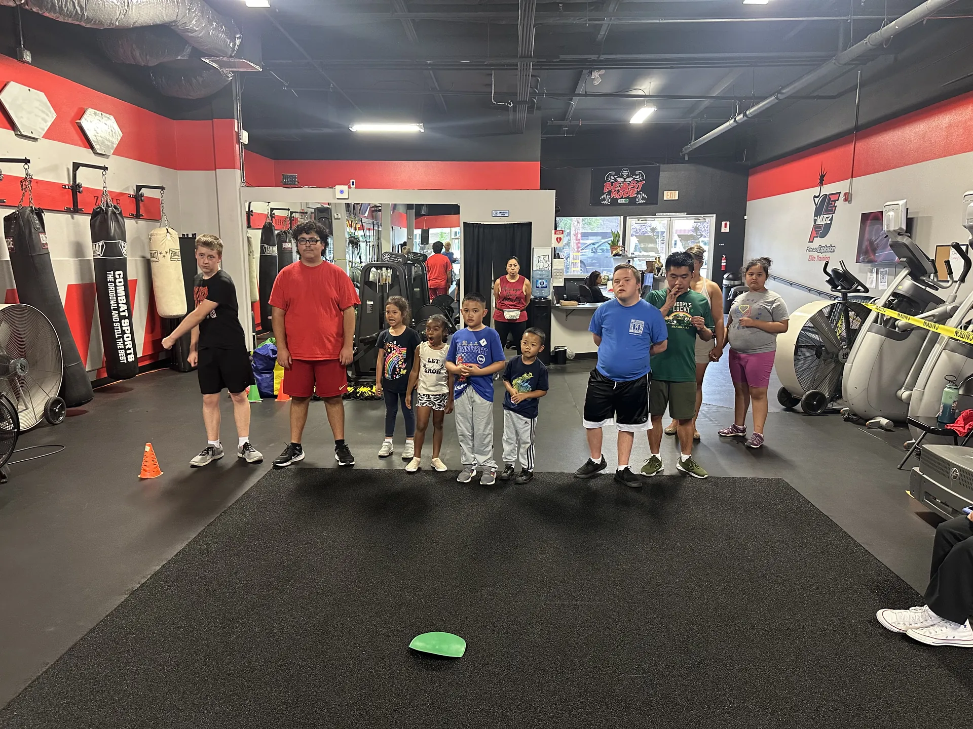 Adaptive Recreation class at Fitness Explosion — kids and coaches lined up together at the gym