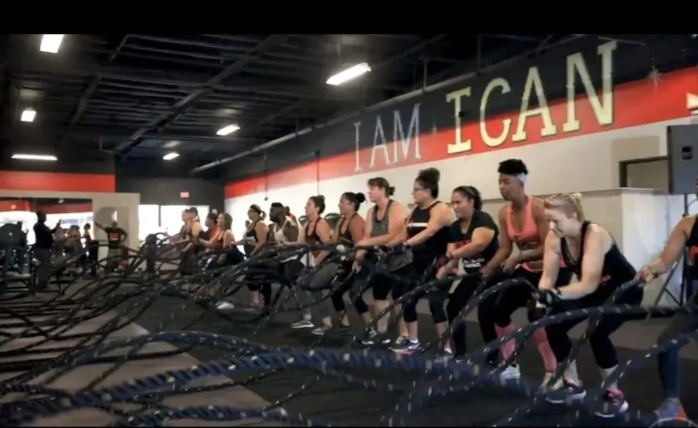 Member training with battle ropes at Fitness Explosion