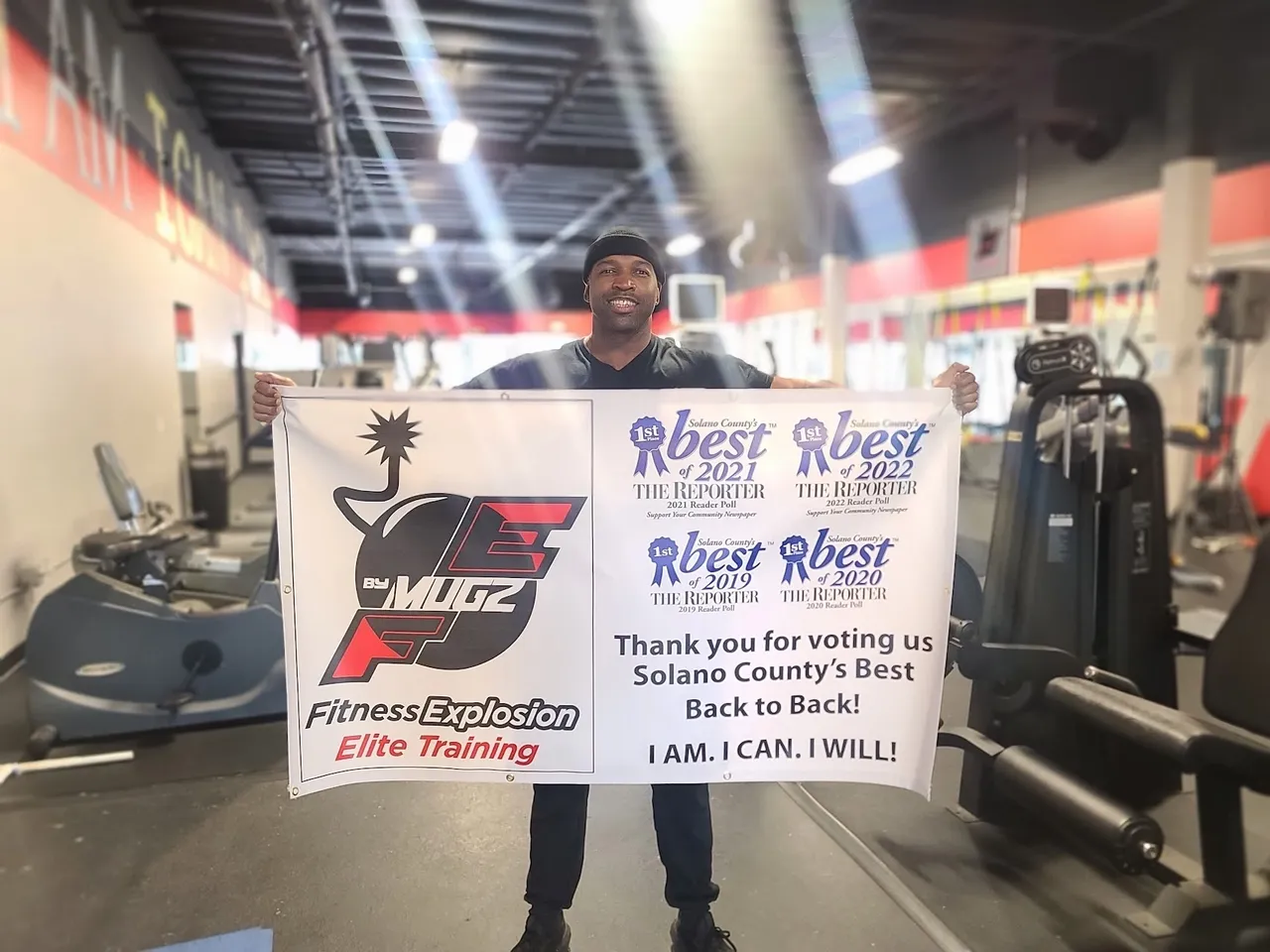 Coach Mugz holding Solano County Best of 2019-2024 awards banner