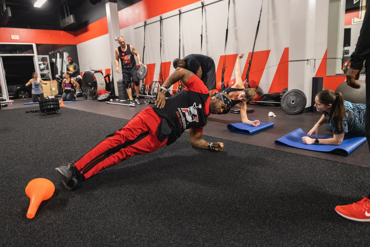 Coach Mugz leading floor training exercises