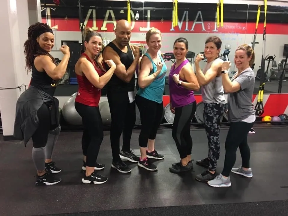 Fit Fam group flexing in the gym mirror