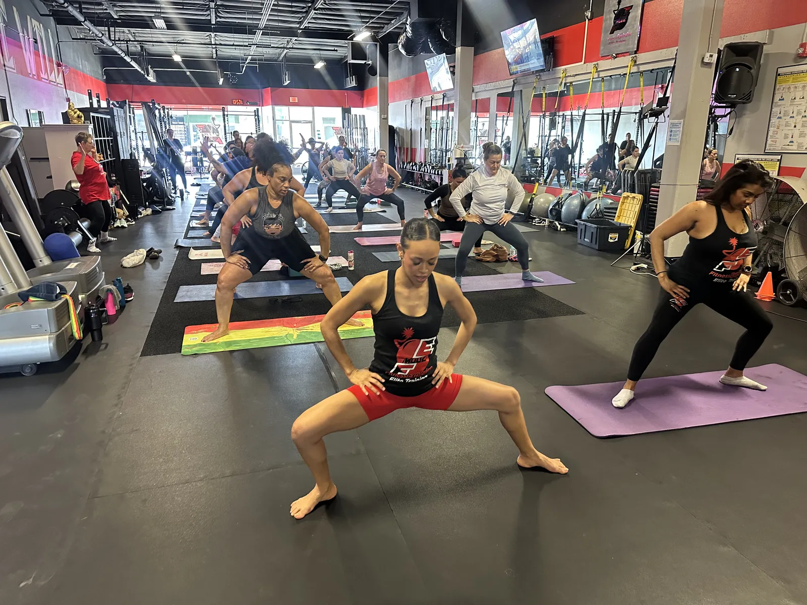 Dumbbell Rock class — members in side lunge formation