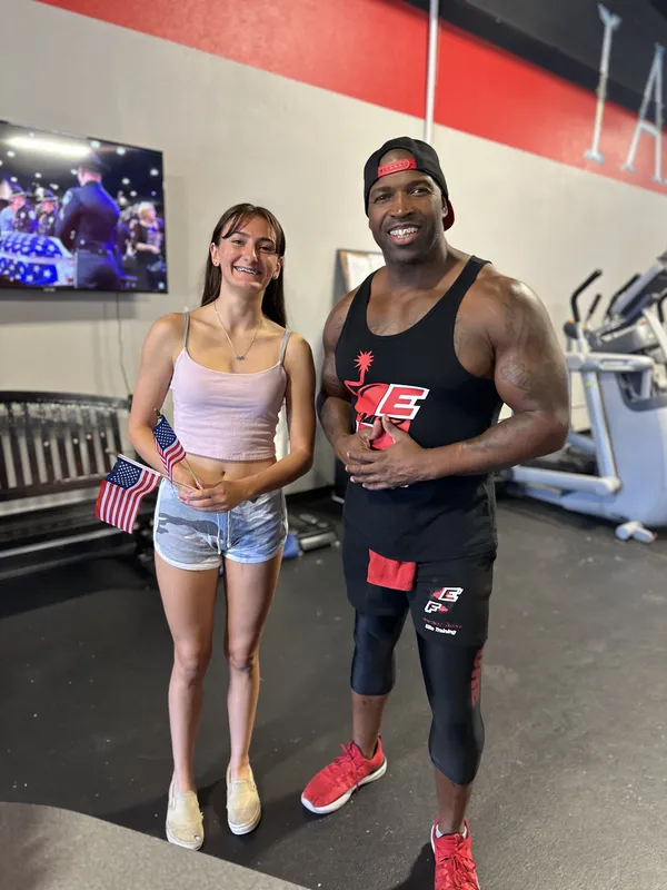 Coach Mugz with member celebrating with American flags