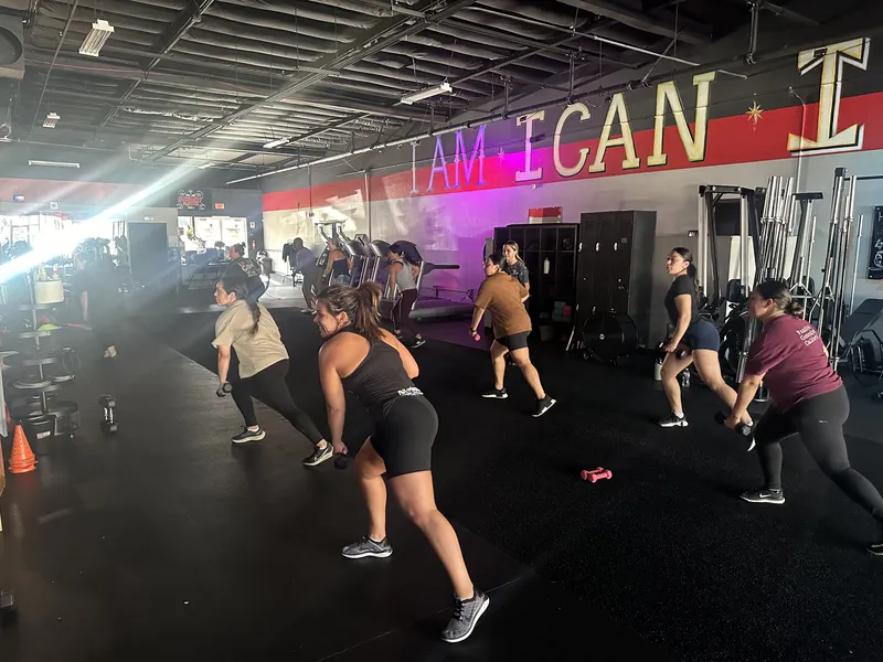 High-energy group class with Dumbbell Rock movements