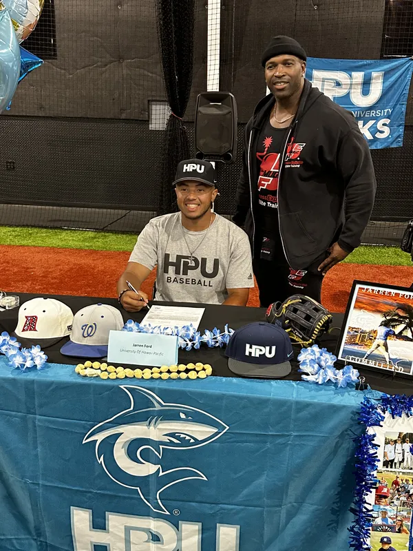 Athletic Training — FE athlete at HPU Sharks college signing table with Coach Mugz
