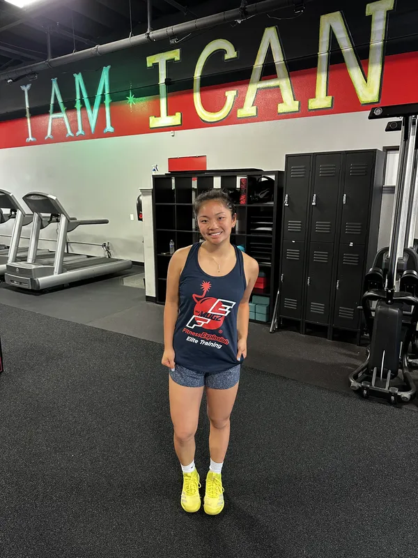 Young FE athlete standing proud in front of I AM I CAN I WILL wall